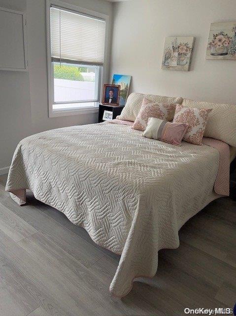 bedroom with hardwood / wood-style flooring