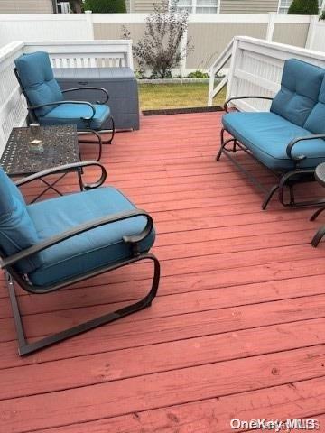 wooden deck with an outdoor living space