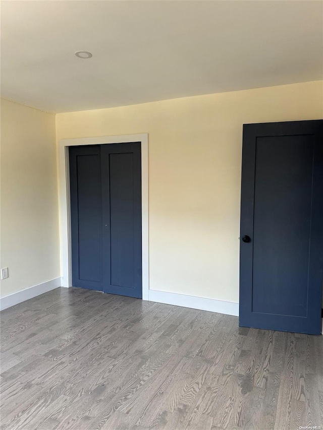 unfurnished bedroom featuring a closet and light hardwood / wood-style flooring