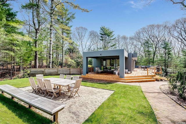 rear view of house featuring a yard and a wooden deck