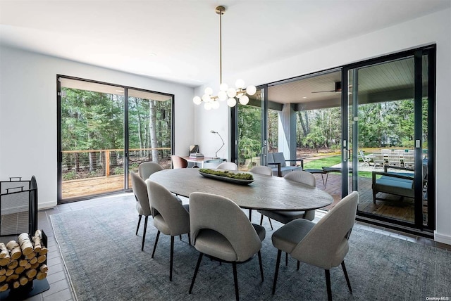 dining room featuring plenty of natural light, ceiling fan with notable chandelier, and hardwood / wood-style flooring