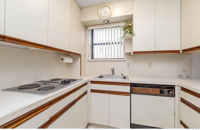 kitchen with white cabinetry, white appliances, and sink