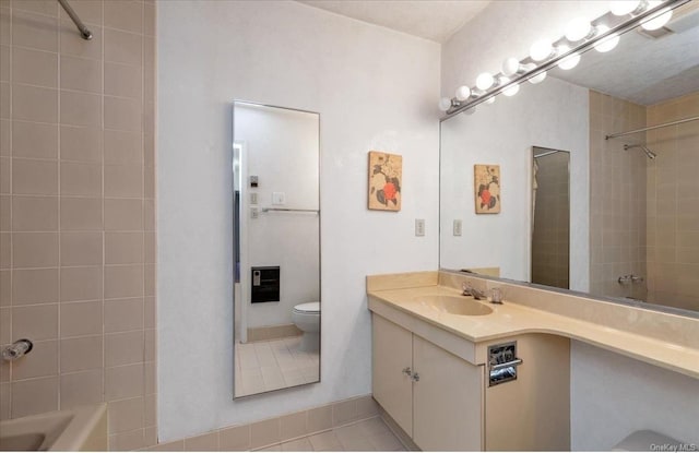 bathroom featuring tile patterned flooring, vanity, and toilet