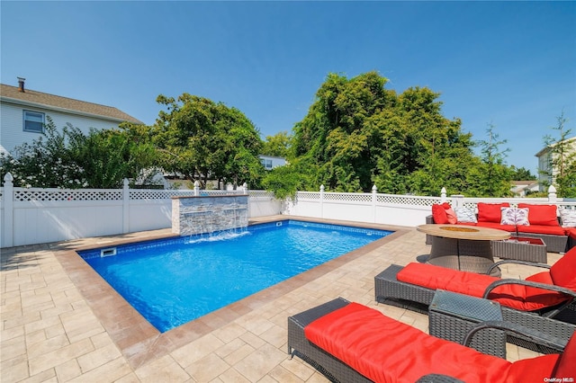 view of pool with pool water feature, a patio area, and outdoor lounge area