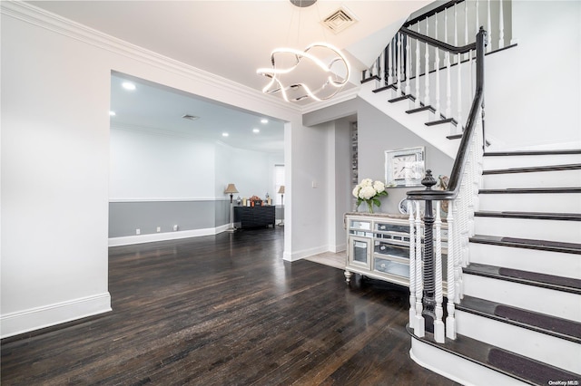 stairs featuring a chandelier, wood-type flooring, and ornamental molding