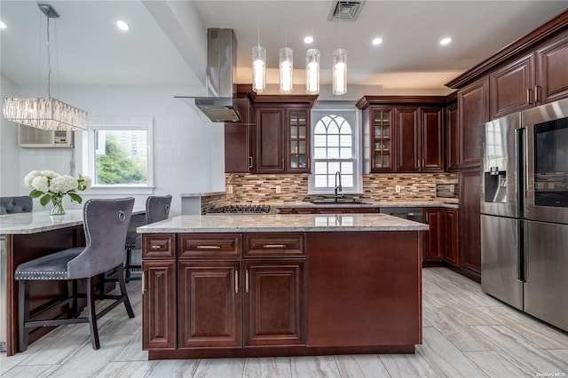 kitchen with island exhaust hood, stainless steel fridge with ice dispenser, sink, and hanging light fixtures