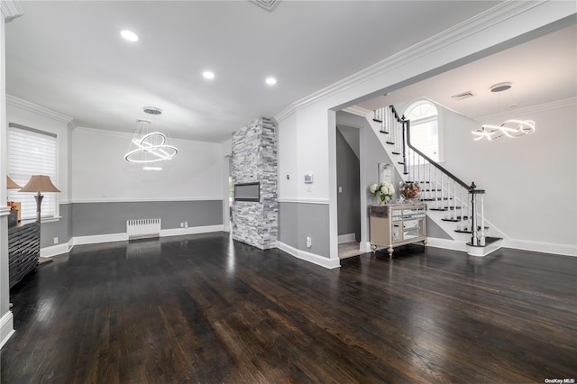 living room with a chandelier, dark hardwood / wood-style flooring, and ornamental molding