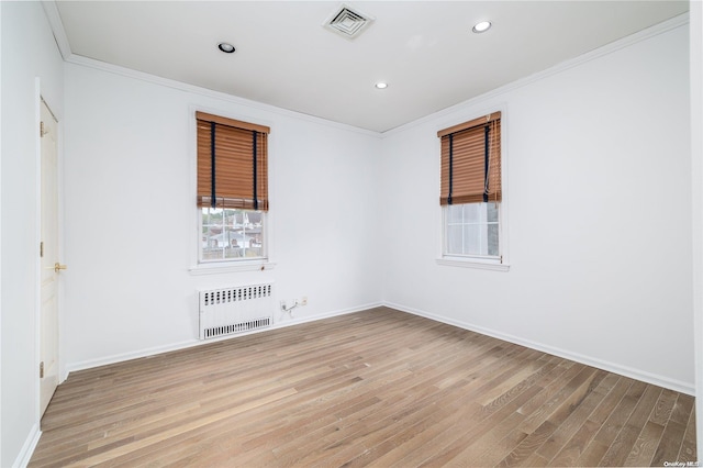26-44 211th St, Bayside, NY 11360 - spare room featuring radiator, light wood-style flooring, ornamental molding, baseboards, and recessed lighting