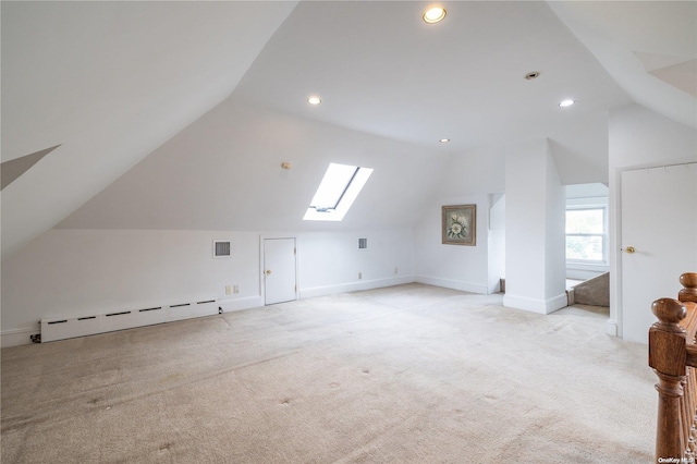 bonus room with vaulted ceiling with skylight, light colored carpet, and a baseboard heating unit