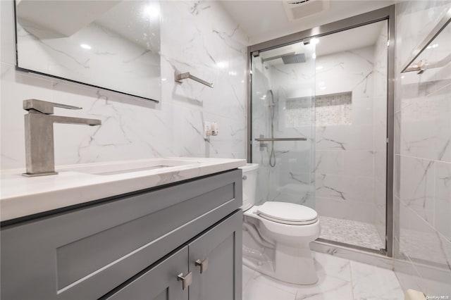 bathroom featuring vanity, toilet, and a shower with shower door