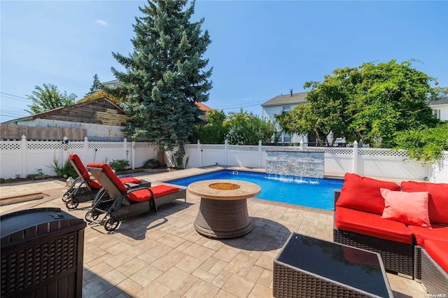 view of swimming pool with a patio, pool water feature, and a fire pit