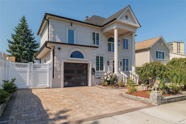 greek revival inspired property featuring a garage