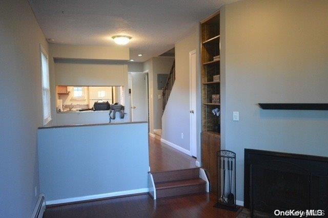 stairs featuring wood-type flooring and a textured ceiling