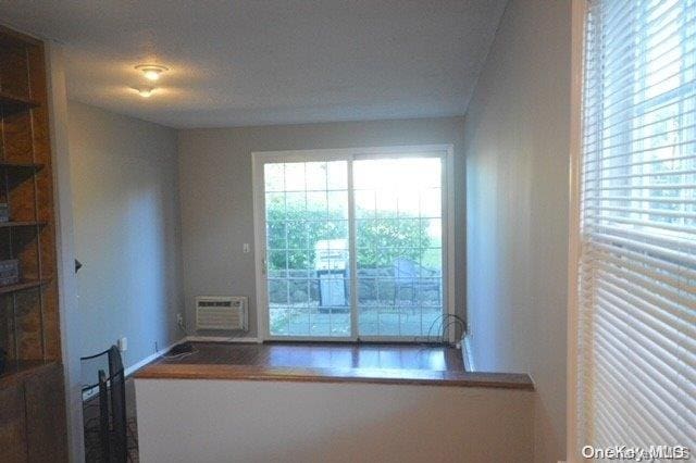 spare room featuring a textured ceiling and an AC wall unit