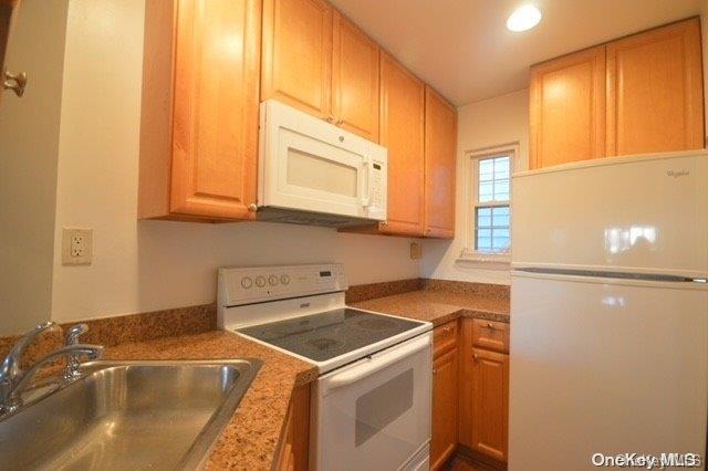 kitchen with white appliances and sink