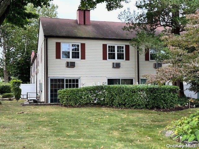 view of property exterior with a lawn