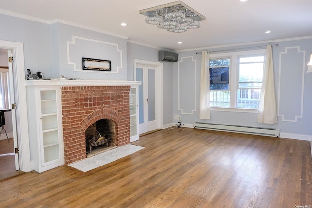 unfurnished living room featuring ornamental molding, a wall unit AC, a baseboard radiator, a fireplace, and hardwood / wood-style floors