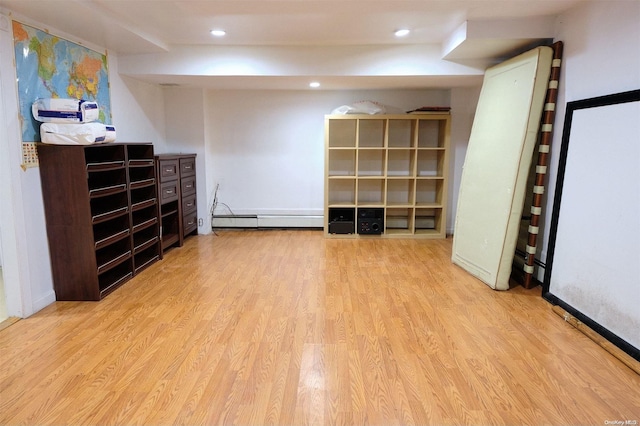 interior space featuring baseboard heating and light wood-type flooring