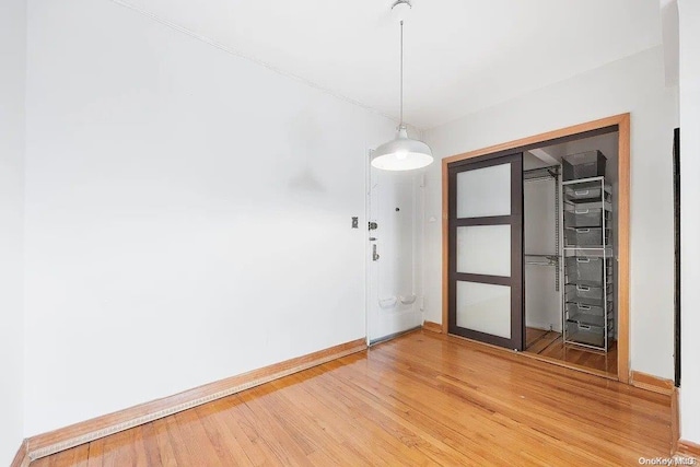 unfurnished room with wood-type flooring