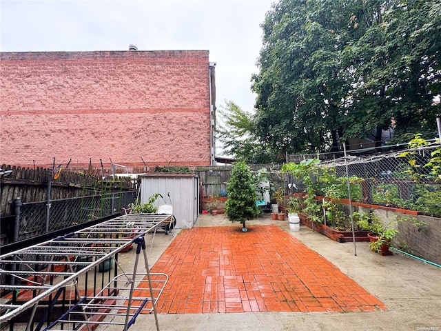 view of patio / terrace featuring a storage unit