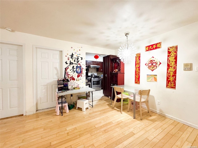 dining area featuring an inviting chandelier and light wood-type flooring