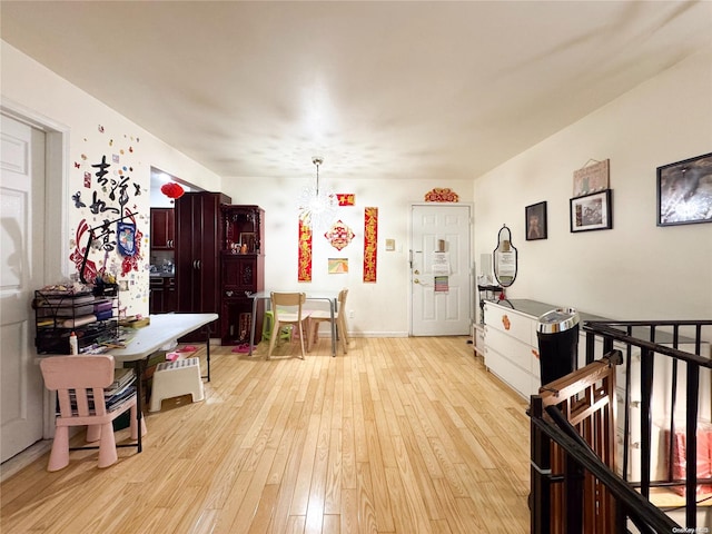 interior space with light hardwood / wood-style flooring and hanging light fixtures