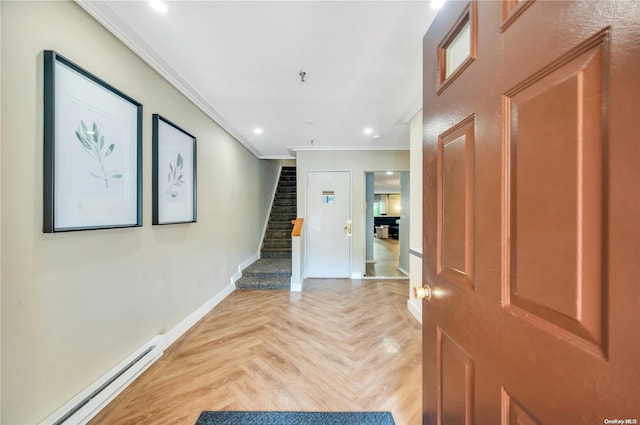 entryway featuring crown molding, baseboard heating, and light parquet floors