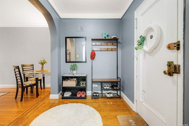 interior space with hardwood / wood-style floors and crown molding