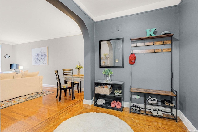 living room with crown molding and wood-type flooring