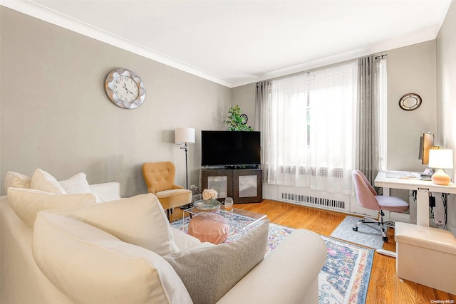 living room with light hardwood / wood-style floors and crown molding