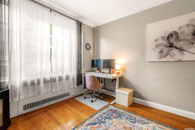 office with hardwood / wood-style floors and ornamental molding