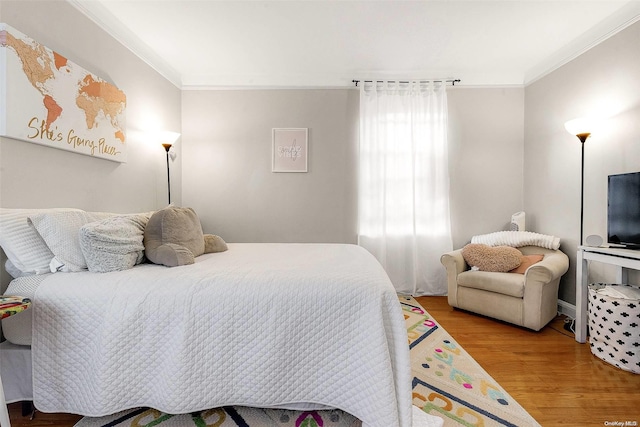 bedroom with crown molding and wood-type flooring