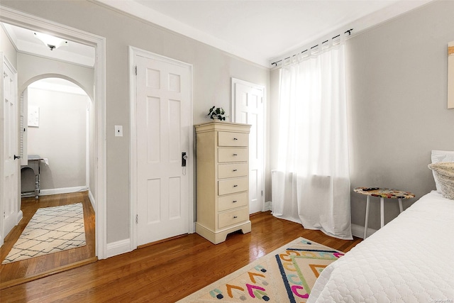 bedroom with hardwood / wood-style flooring and crown molding