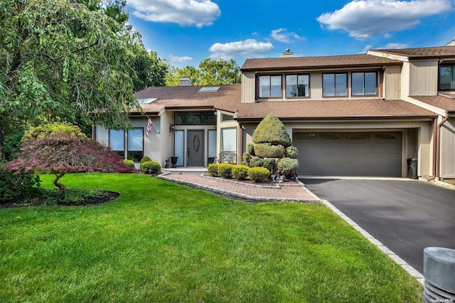 view of front facade featuring a front yard and a garage