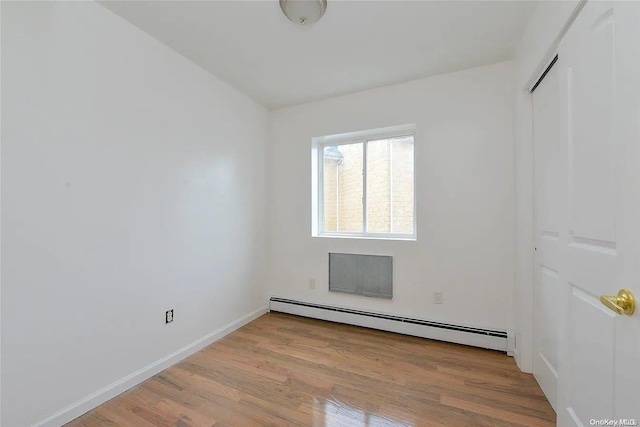 empty room featuring light hardwood / wood-style flooring and baseboard heating