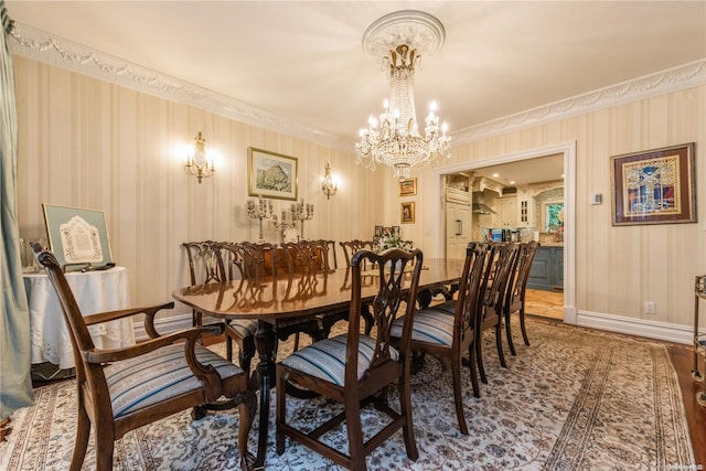 dining area featuring hardwood / wood-style floors, crown molding, and a chandelier