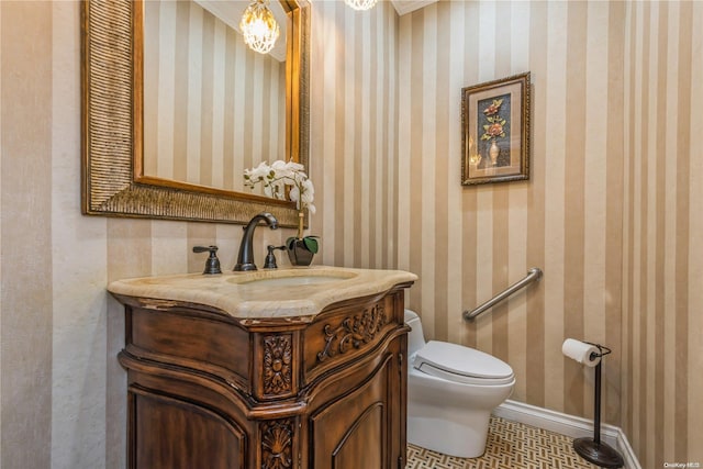 bathroom featuring tile patterned floors, vanity, and toilet