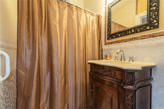 bathroom featuring vanity and tile walls