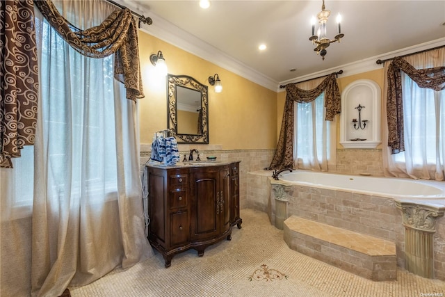 bathroom featuring tile patterned floors, crown molding, vanity, and a relaxing tiled tub