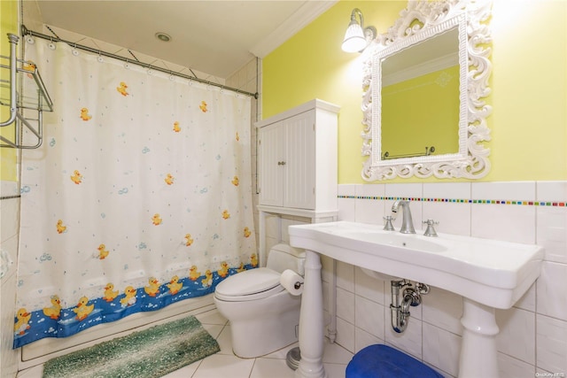 bathroom with tile patterned floors, ornamental molding, tile walls, and toilet