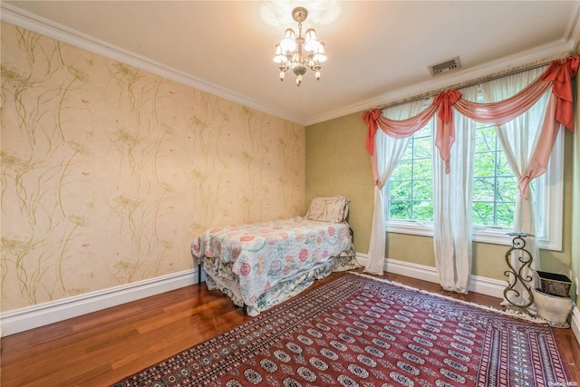 bedroom with a chandelier, hardwood / wood-style flooring, and ornamental molding