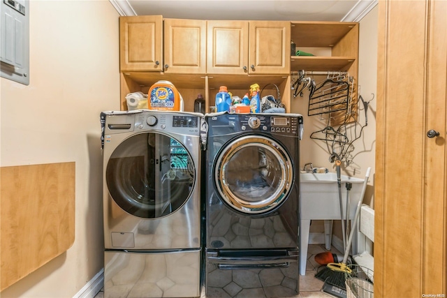 laundry area featuring tile patterned floors, separate washer and dryer, cabinets, and ornamental molding