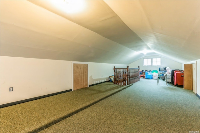 bonus room featuring carpet floors and vaulted ceiling