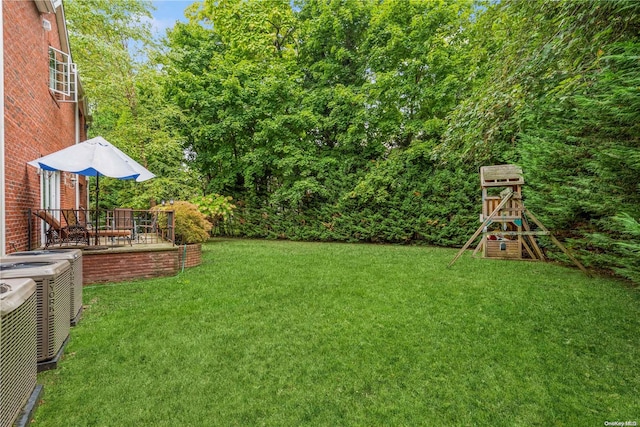 view of yard with a playground and central AC unit