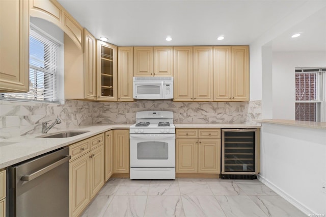 kitchen featuring sink, beverage cooler, white appliances, and light brown cabinets