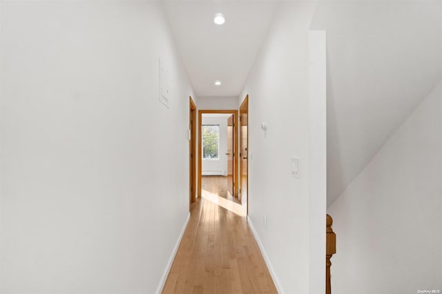 hallway with light hardwood / wood-style floors