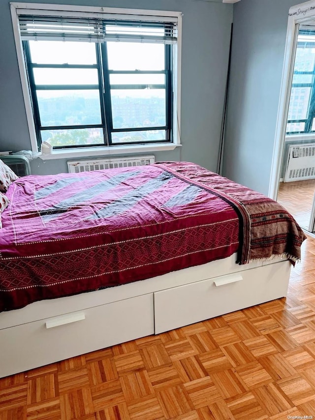 bedroom with light parquet floors