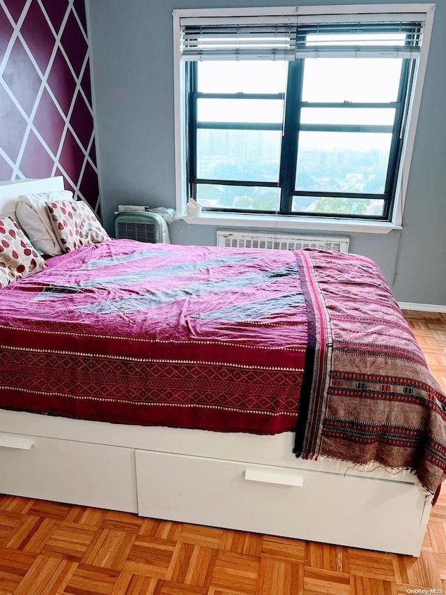 bedroom with light parquet flooring and multiple windows