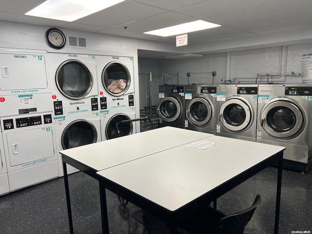 laundry room featuring washing machine and dryer and stacked washer / dryer