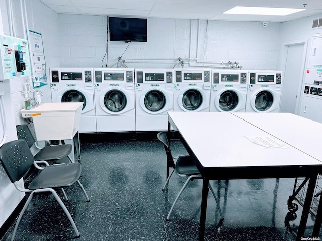 washroom with stacked washing maching and dryer and washer and dryer